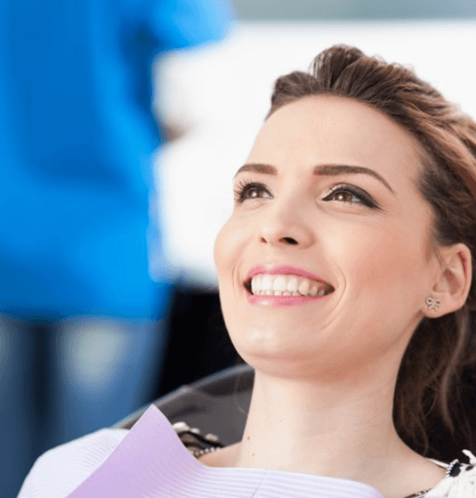 a patient smiling after undergoing the clear aligner process