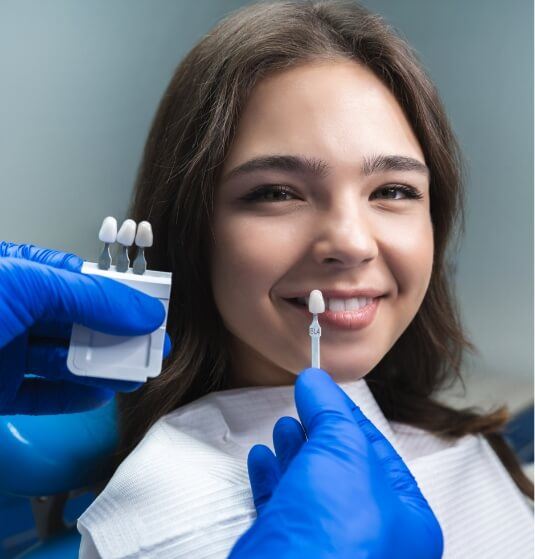Young woman trying on veneers while visiting cosmetic dentist in Jacksonville