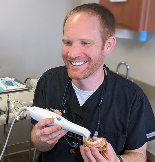Doctor Altenbach taking a digital dental impression of a denture