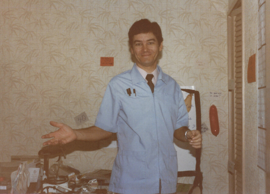 Doctor Robert Wagner standing in room with palm tree themed wallpaper