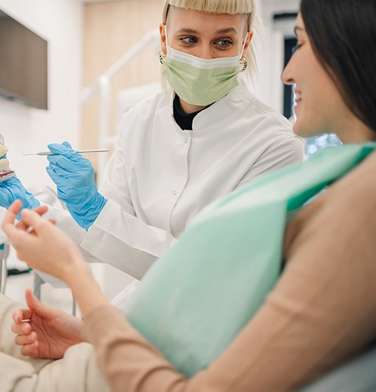 Dentist discussing how a smile makeover works with patient