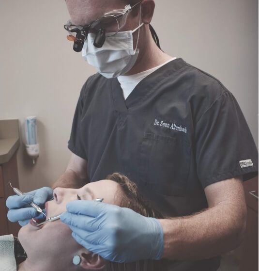 Doctor Altenbach examining a patient's mouth during a dental checkup in Jacksonville