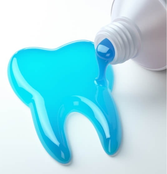 Blue toothpaste spilling out of tube in shape of tooth