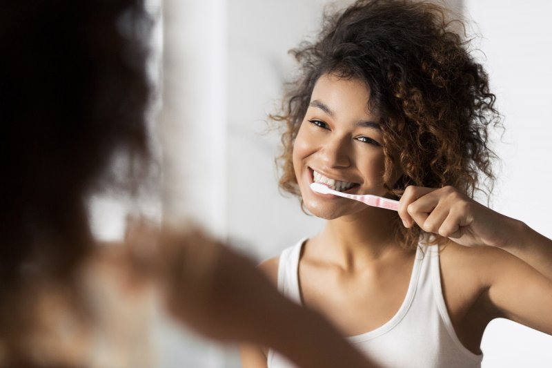Woman brushing her teeth for teeth whitening