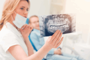 Dentist reviewing an X-ray with her patient